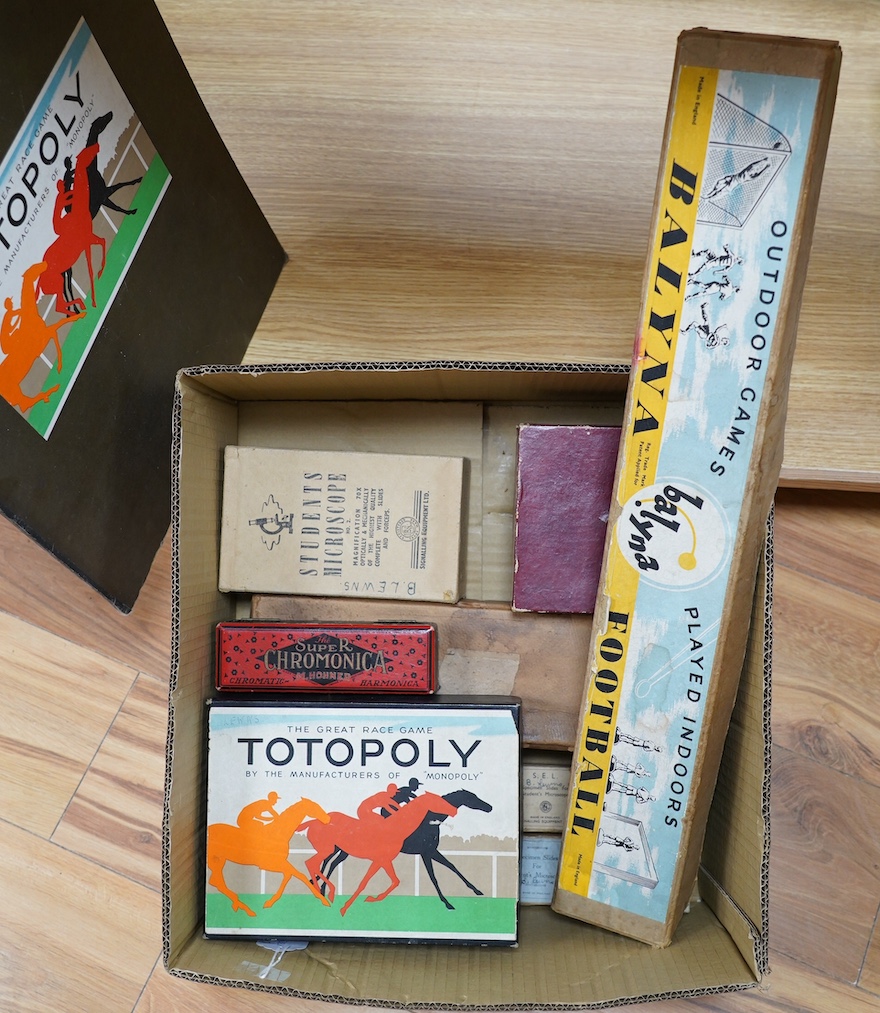 Eight 20th century to mid 20th century toys etc. including; an early boxed Subbuteo table soccer goal post set, a student microscope with slides, a boxed Balyna table football set, a Totopoly board game, a leatherworking